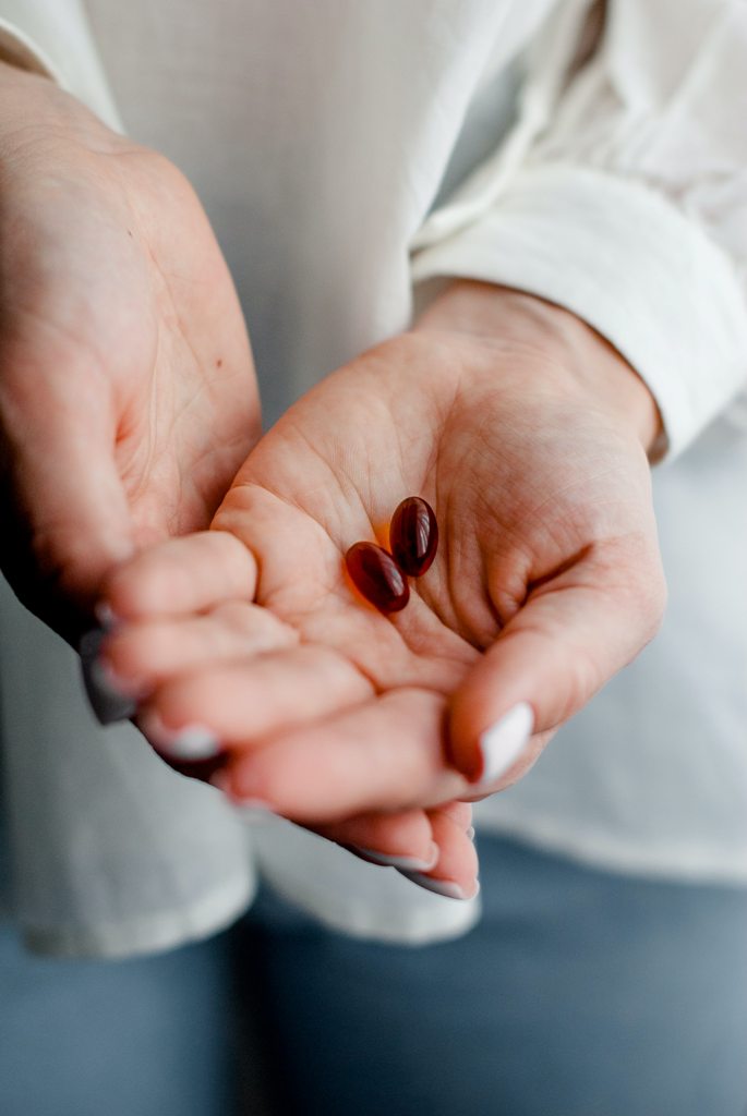 Guy holding marineomega(fish oil)